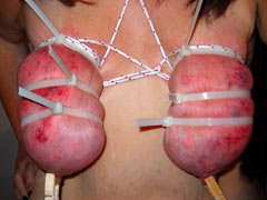 Group using the pierced pussy of slave as ashtray