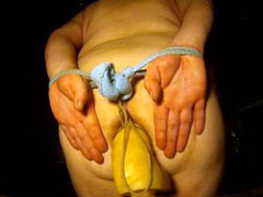 Girl is trying to withstand the pain of tightly bound boobs for several hours